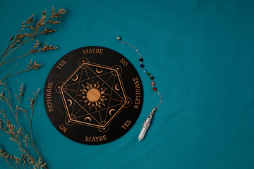 Pendulum board for divination, fortune telling or communicating with spirits. Magical crafting, witchcraft idea