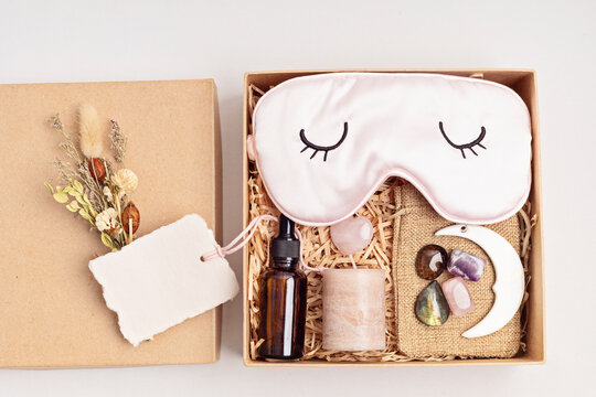 Gift box for improving sleep quality with gemstones. Healing chakra crystals, candle, essential oil and sleeping mask. Care package for natural treatment of insomnia