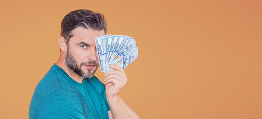 Man with money cash. 100 dollars banknotes. Portrait of man holding money. Dollar bills, credit, online banking.