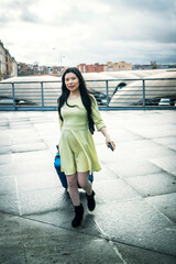 Obraz premium a girl with her blue suitcase and dressed in yellow at the station a girl with her blue suitcase and dressed in yellow at the station a girl with her blue suitcase and dressed in yellow at the station
