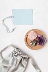 Crystals kit for calming and relaxation. Amethyst, roze quartz, labradorite gemstones for healing anxiety and mental health gift idea. Flat lay, top view with tag mockup © netrun78