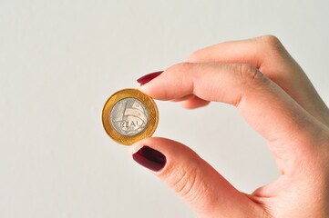 hand holding real coin