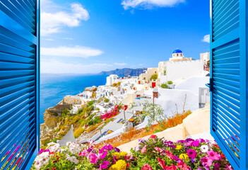 Hillside view through an open window with blue shutters of the blue dome church, caldera, sea and white village of Oia on the island of Santorini, Greece. - obrazy, fototapety, plakaty