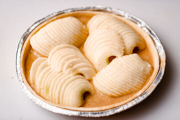 Frozen apple pie. Apples in caramel sauce in foil shape