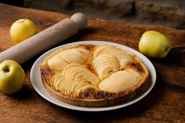Cooked apple pie on wooden background. Finished semi-finished product.