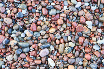 Wet pebbles top view. Beautiful pattern of stones