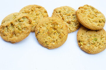 pistachio and almond cookies on white background.
