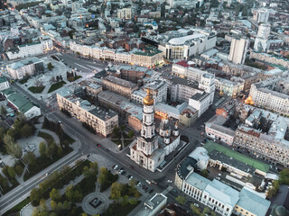 Fototapeta na wymiar Aerial look down view on Dormition Cathedral near Independence square in evening lights of Kharkiv city downtown, Ukraine.