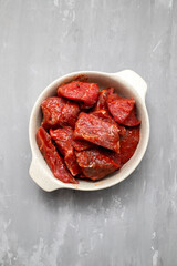 Fresh raw cube of beef in white bowl