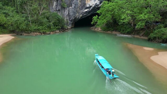 Tourists boats entering Phong NHA underground river cave, Aerial 
Quand bing province Vietnam, february,15, 2023

