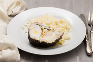 Delicious boiled fish with boiled rice on plate