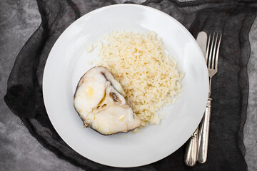 Delicious boiled fish with boiled rice on plate