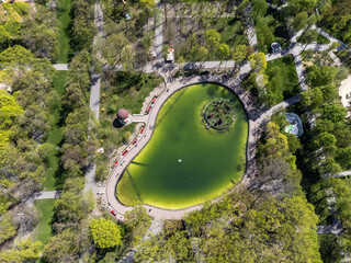 Attractions and decorative pond recreation area in spring greenery. Aerial look down view in Kharkiv city central park