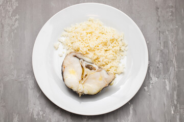 Delicious boiled fish with boiled rice on plate