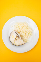 Delicious boiled fish with boiled rice on plate