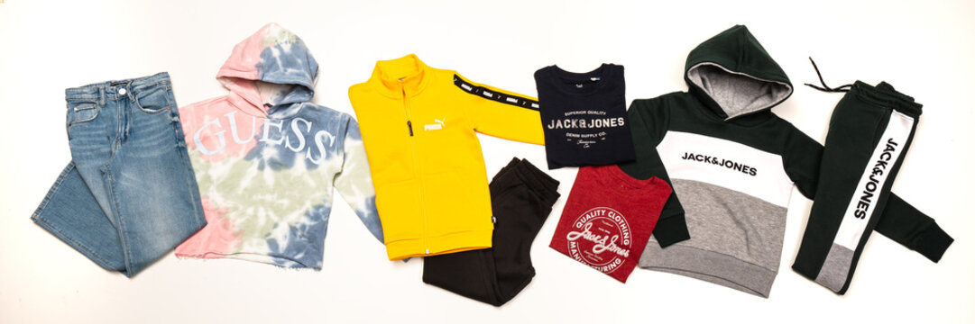 group of casual wear various brands Guess, Jack & Jones, Puma on white background. Udine Italy_March 09 2023