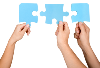 Closeup on Hands Combining Puzzle Pieces Together