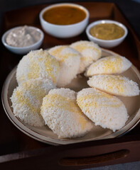 Close up of Idly a south Indian famous healthy steam cooked breakfast. Traditionally served idly with chutneys and sambar. Sprinkled home made clarified butter or Ghee on idly.