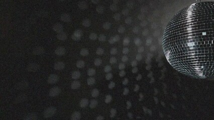 Animation of pink light spot over spinning disco ball against white particles on black background - Powered by Adobe