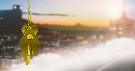 Animation of golden house model with key over defocused aerial view of cityscape at sunset - Powered by Adobe