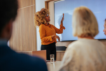 African American businesswoman doing presentation for team.