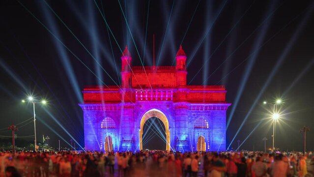 Timelapse view of historic landmark Gateway of India monument illuminated at night in Mumbai, Maharashtra, India.