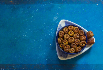 Dates stuffed with Almonds ready for Ramadan days and traditions. 
Presented on a blue background. 