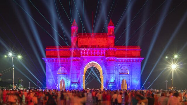 Zoom in timelapse of historic landmark Gateway of India monument illuminated at night in Mumbai, Maharashtra, India.
