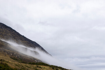 Misty morning with thick fog hanging in the mountains at the confluence of Baker River and Chacabuco River in the Chilean part of Patagonia - natural sight along the Carretera Austral 