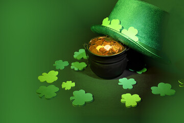 St. Patrick’s day, pot of gold coins, leprechaun hat and shamrocks, on green background, with...