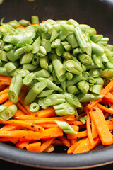 Sizzling Chopped Green Beans and Carrots in Frying Pan