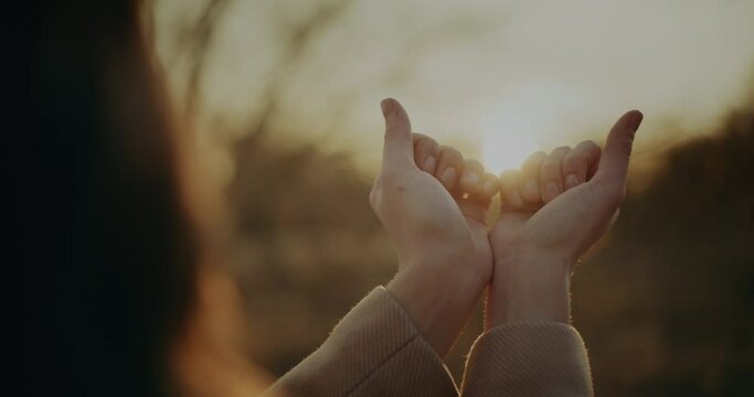 Woman Holding Sun Beams in Her Hands