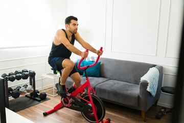 Handsome fit man doing cardio exercises at home