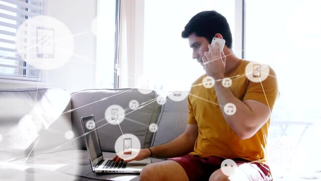 Animation of network of connections with icons over caucasian man using laptop