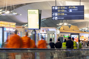 Buddhist monks ride with people on a moving walkway at the international airport - Powered by Adobe