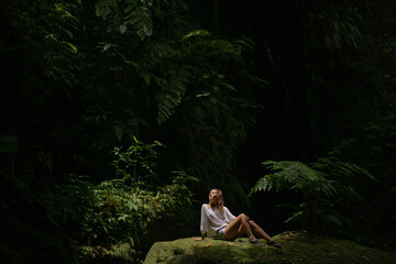 Fototapeta premium Young woman walks in a tropical jungle park, Bali.