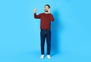 Man talking on smartphone against light blue background