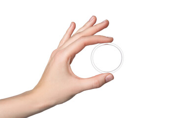 Woman holding diaphragm vaginal contraceptive ring on white background, closeup