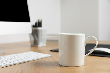 Naklejka na ściany i meble Blank ceramic mug on wooden table. Mockup for design