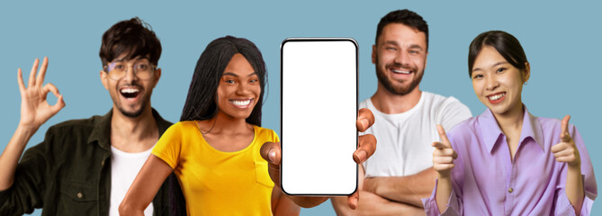 Smiling multiracial people show smartphone with empty screen, make ok sign hand isolated on blue...