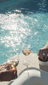 Drinking wine by the pool with sunlight summer