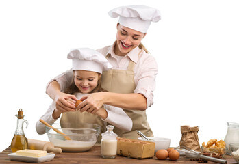 The beautiful young mother and her little daughter cook at home