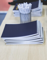 Gift bag package for conference participants before start, with a leaflet handout, notebook...