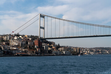 View of Sultan Mehmed Fatih Bridge and the embankment of the European part of Istanbul from the water area of the Bosphorus on a sunny day, Istanbul, Turkey
