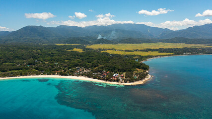 Tropical landscape with a beautiful beach in the blue water. Pagudpud, Ilocos Norte, Philippines.