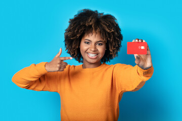 Happy black lady showing black card at camera