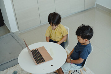 Children focused on their online classes with their teacher