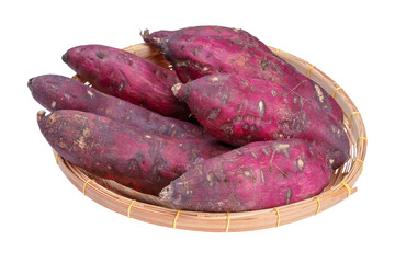 Collection of whole raw Japanese sweet potatoes on wicker basket.