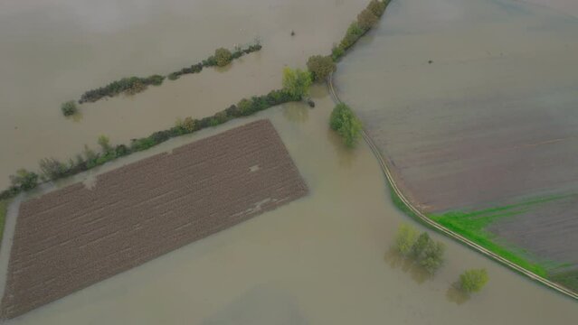 AERIAL: Agricultural land under muddy flood water after heavy autumn rainfall. Due to abundant rains in fall season, river overflowed over its banks and inundated big farmland area in the countryside.