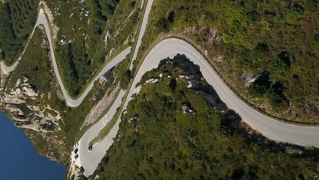 Curvy road through Cap Canaille cliffs, French coast Mediterranean Sea. Vertical aerial.